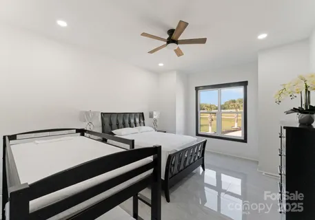 a bedroom with a bed and a tv