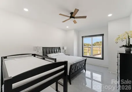 a bedroom with a bed and a tv