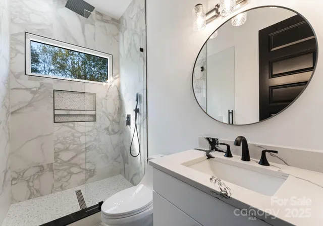 a bathroom with a sink a toilet and a mirror