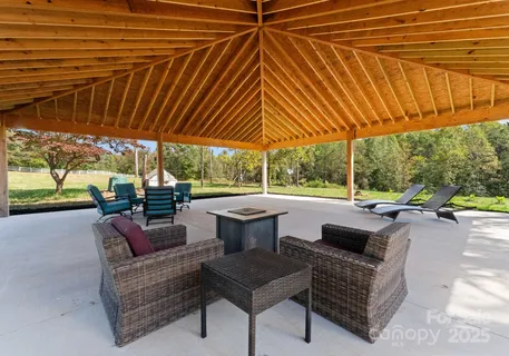 a view of patio with couches and pool