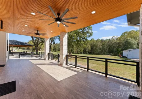 a view of a terrace with hardwood and floor to ceiling window