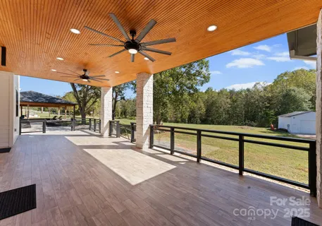 a view of a terrace with hardwood and floor to ceiling window