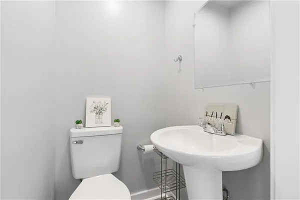 a bathroom with a sink a toilet and mirror