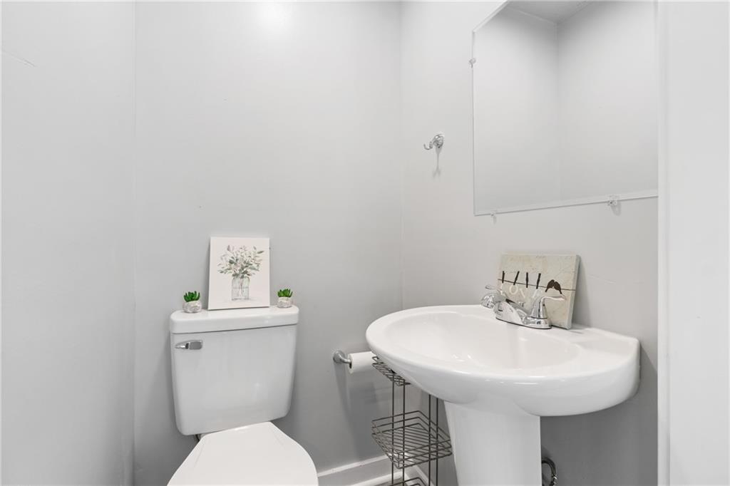 145 Georgetown Avenue Pittsburgh, PA 15229 - Photo 15 of 22 a bathroom with a sink a toilet and mirror