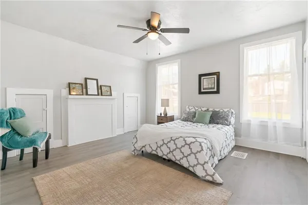 a bedroom with a bed and a chandelier