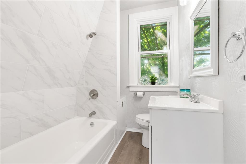 145 Georgetown Avenue Pittsburgh, PA 15229 - Photo 18 of 22 a bathroom with a sink a bathtub window and a toilet