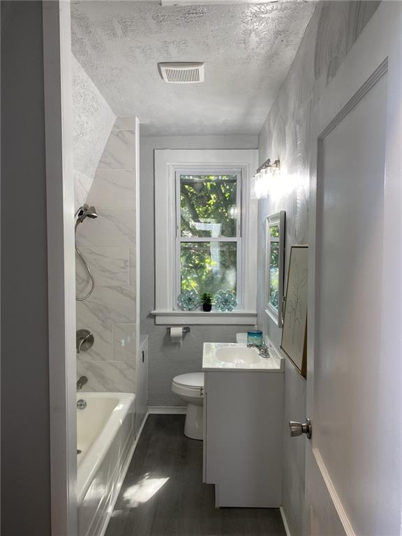 145 Georgetown Avenue Pittsburgh, PA 15229 - Photo 19 of 22 a bathroom with a tub a sink and a large mirror