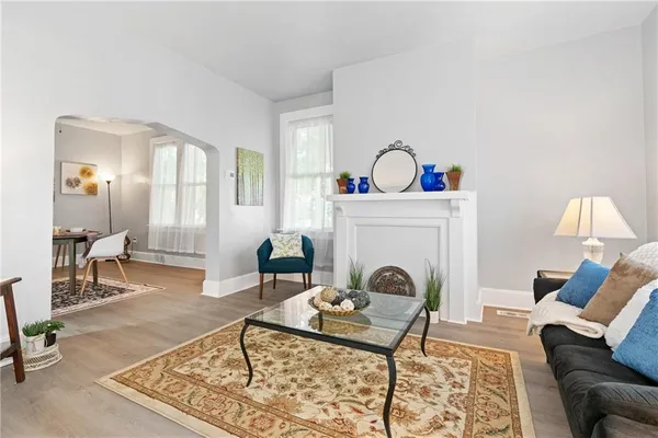 a living room with furniture and a fireplace
