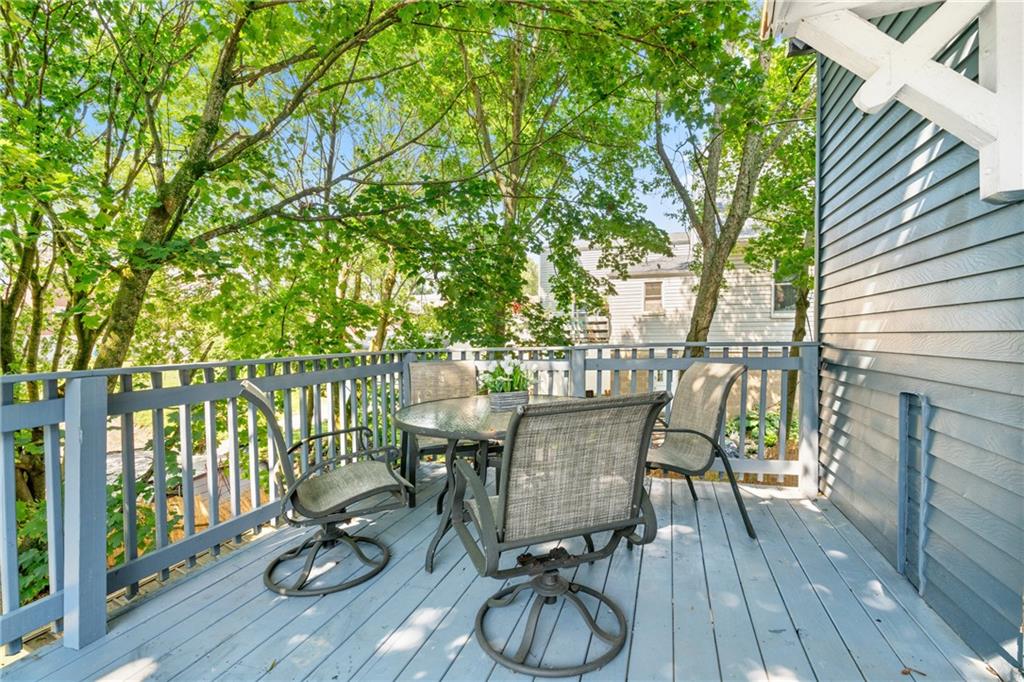145 Georgetown Avenue Pittsburgh, PA 15229 - Photo 10 of 22 a view of a patio with table and chairs with wooden floor and fence