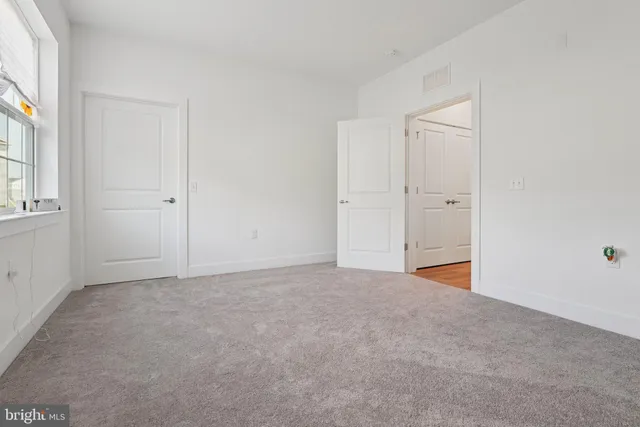 a bed room with a bed and a window