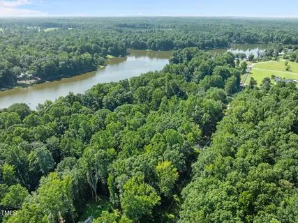 an aerial view of a houses with a lake view