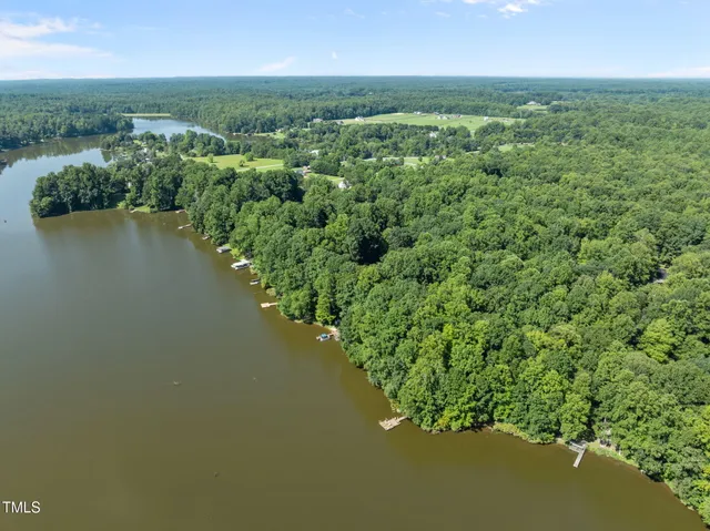 an aerial view of residential houses with outdoor space and river