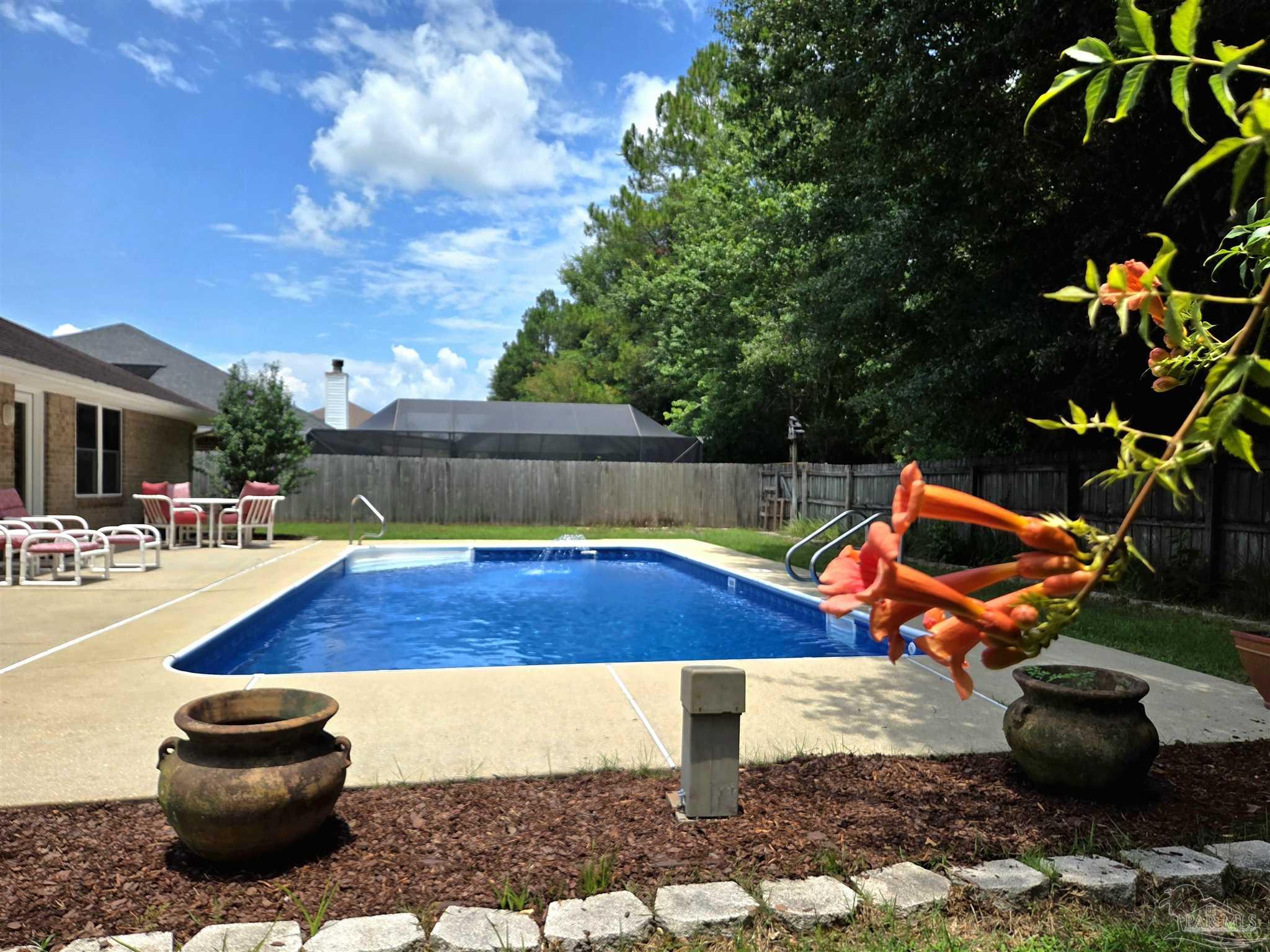 a view of a backyard with swimming pool