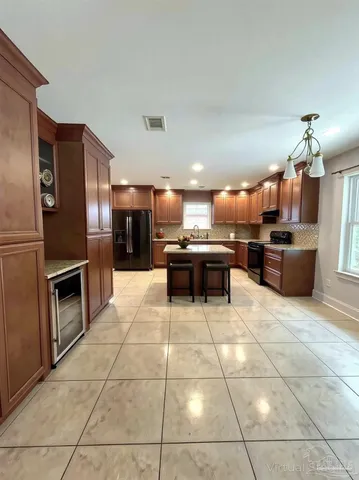 a view of a livingroom with wooden floor fireplace and window