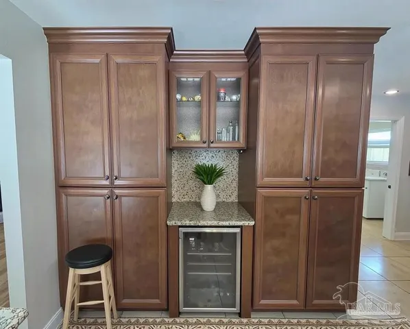 a spacious bathroom with a double vanity sink a toilet a mirror and a window