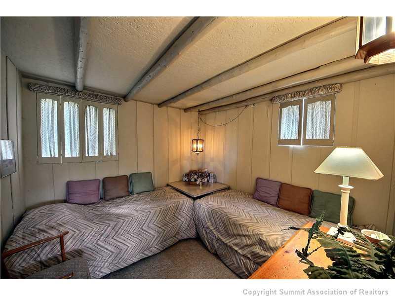 123 J Road Silverthorne, CO 80498 - Photo 9 of 17 a bedroom with a bed and a chair