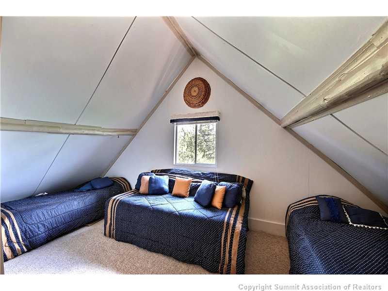 123 J Road Silverthorne, CO 80498 - Photo 10 of 17 a bedroom with furniture and a window