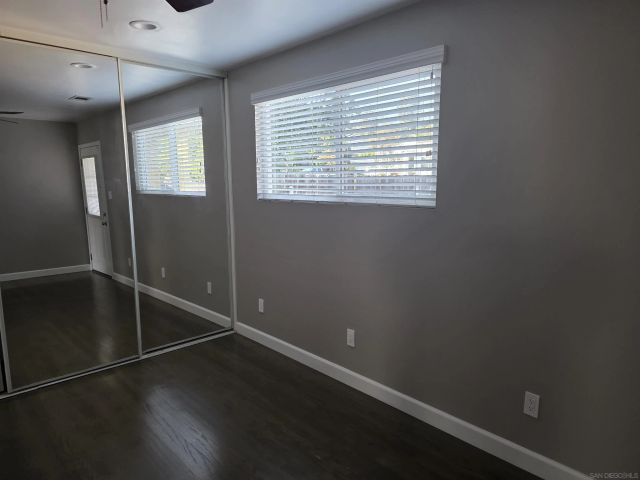 a backyard of a house with wooden fence