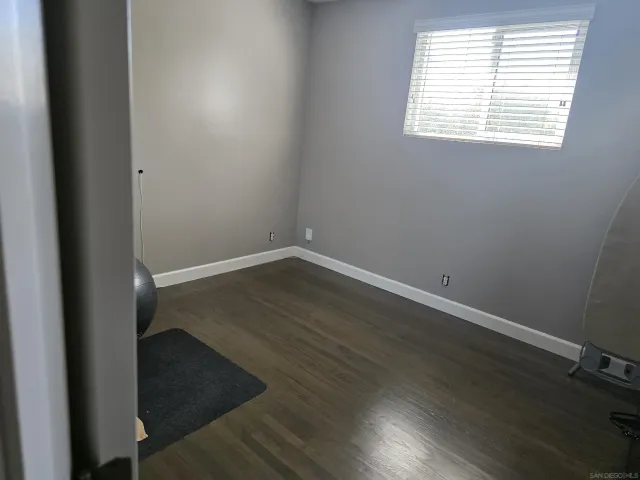 a view of a yard with wooden fence