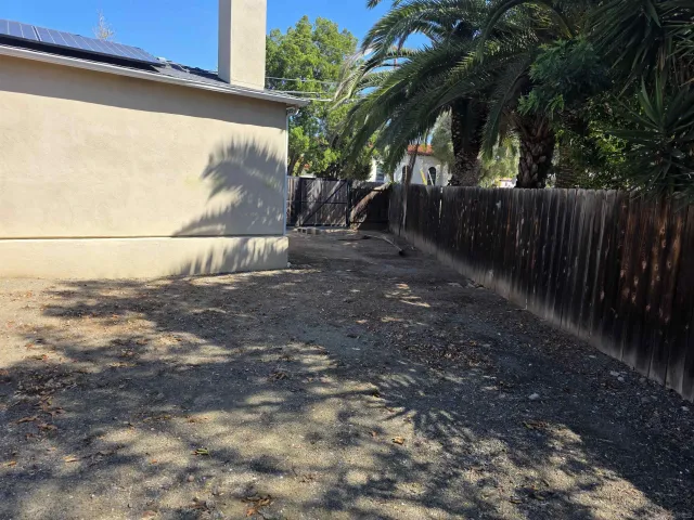 a backyard of a house with table and chairs