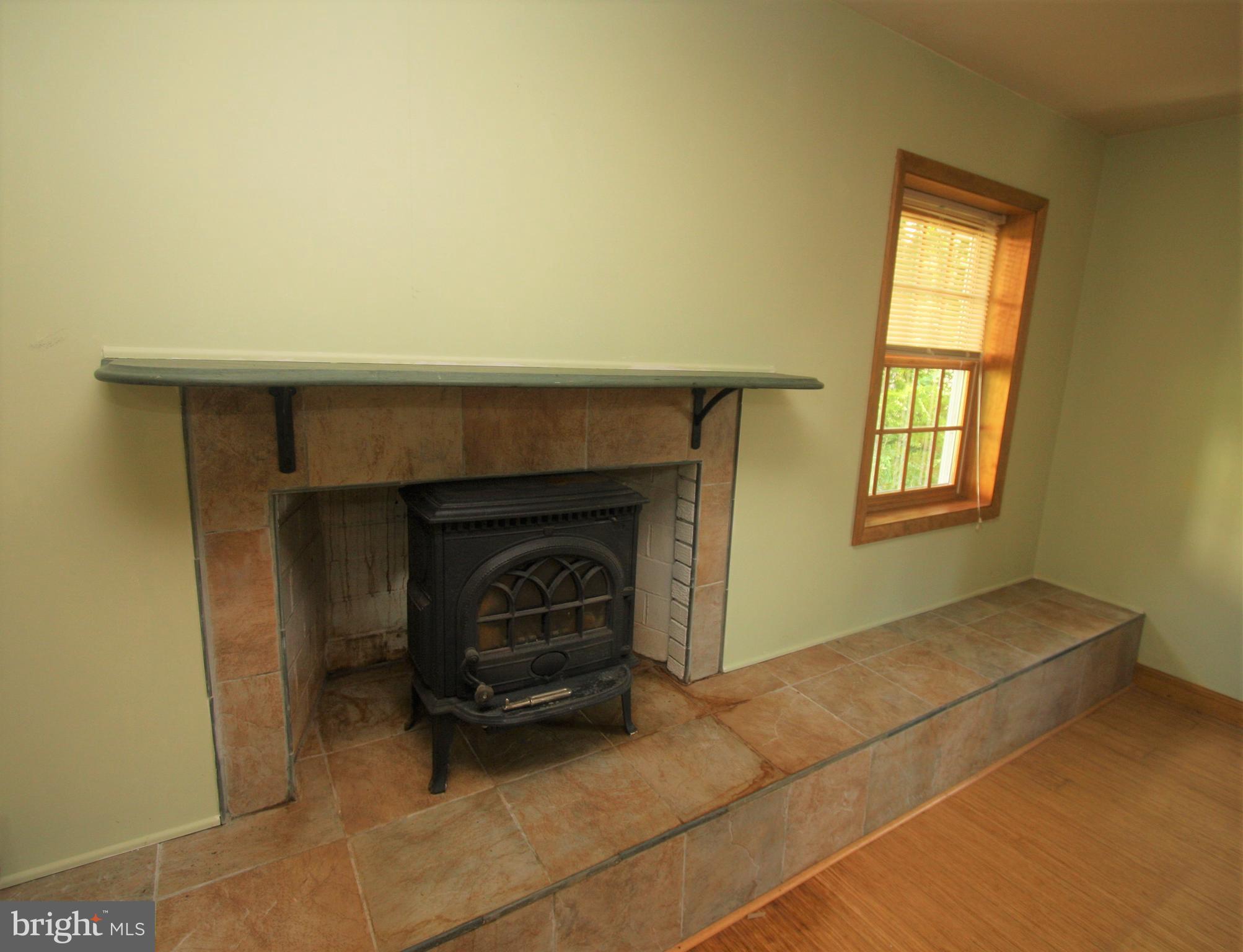 5001 West Running Brook Road Columbia, MD 21044 - Photo 12 of 26 Wood stove in Fireplace with Raised Hearth