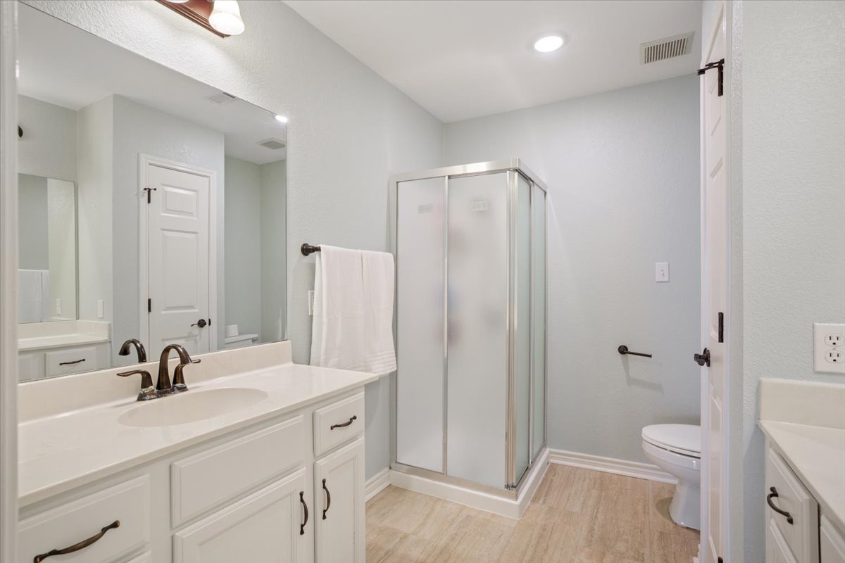 8600 Five Wells Road Rogers, TX 76569 - Photo 20 of 40 Full bath with vanity, a stall shower, light wood-type flooring, and recessed lighting