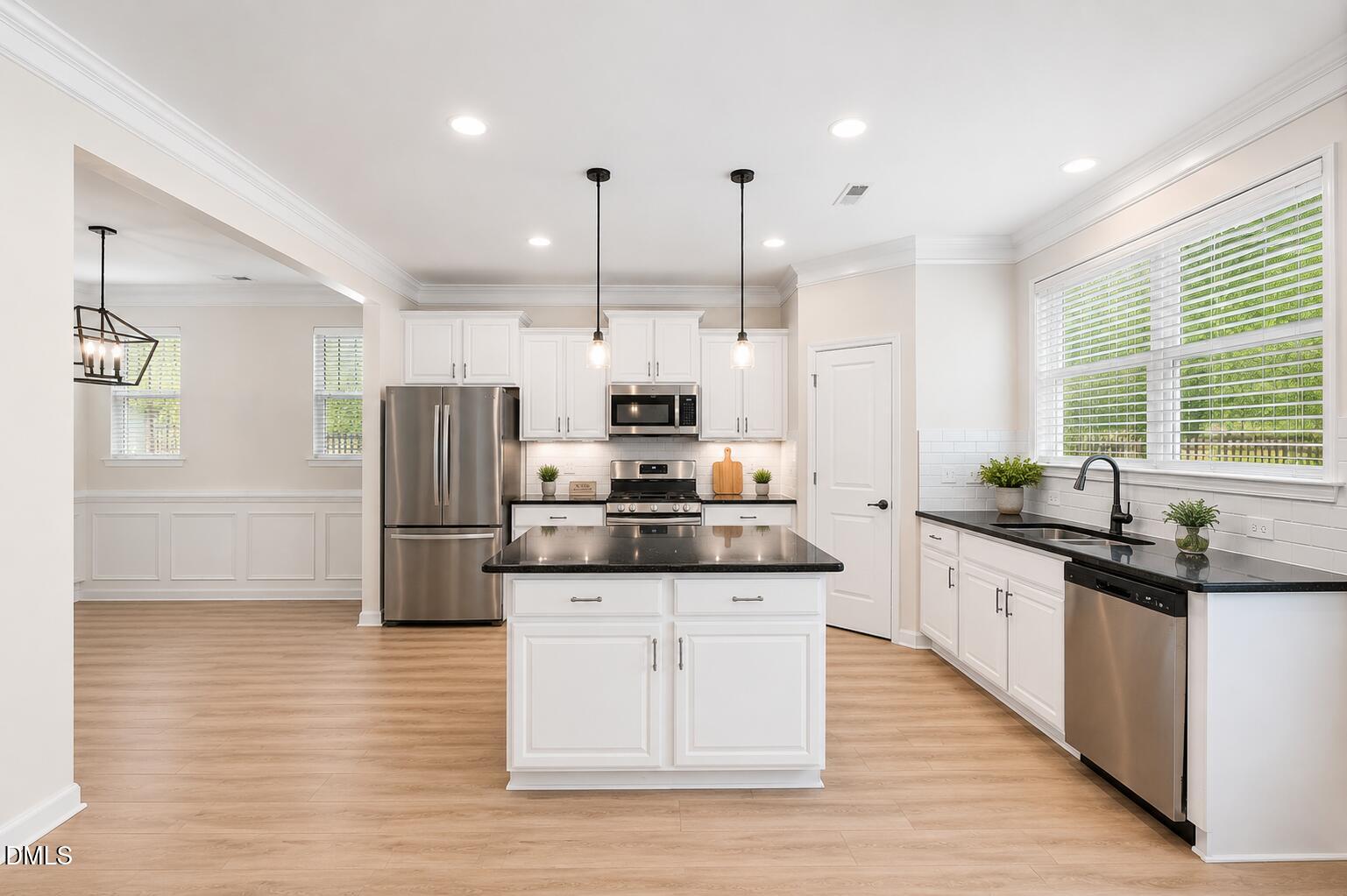 364 Springtime Fields Lane Wake Forest, NC 27587 - Photo 17 of 63 a kitchen with stainless steel appliances kitchen island granite countertop a refrigerator a sink dishwasher a stove with white cabinets and wooden floor