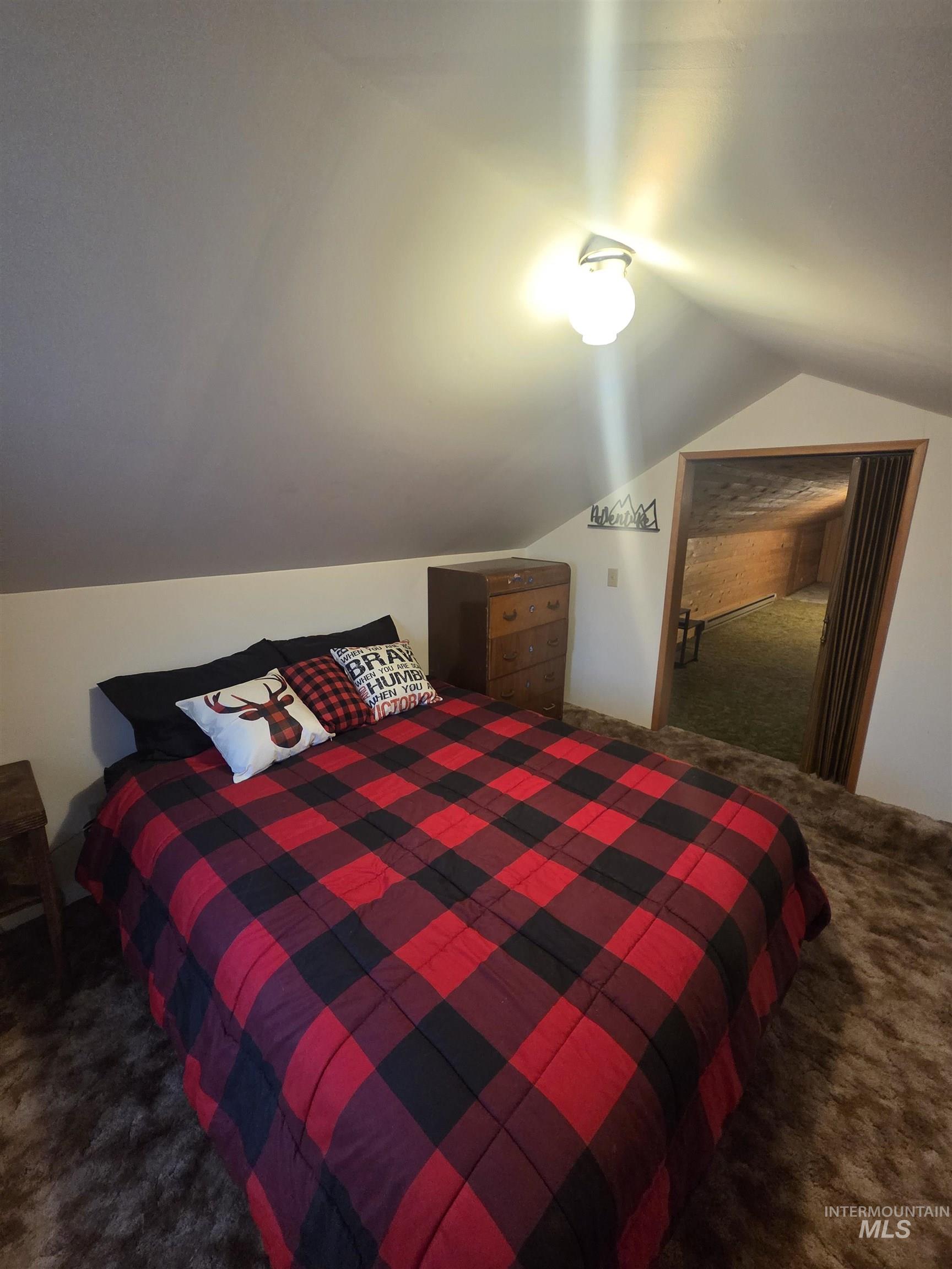 1607 Main Street Pomeroy, WA 99347 - Photo 11 of 28 Bedroom with carpet floors and vaulted ceiling