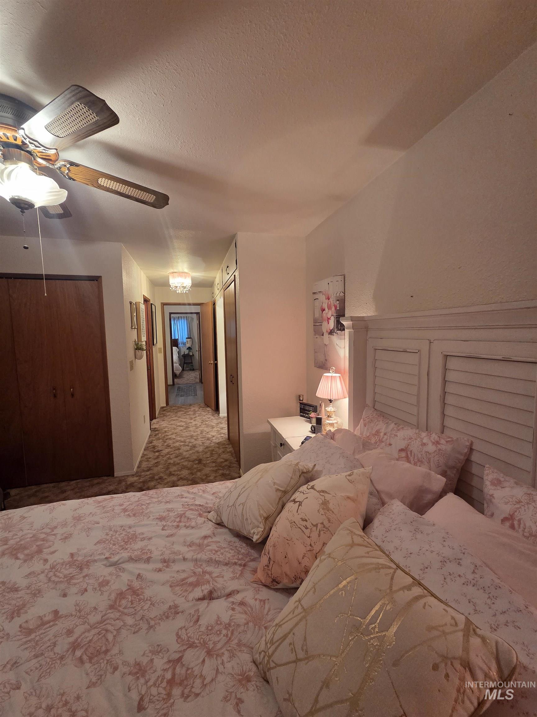 1607 Main Street Pomeroy, WA 99347 - Photo 17 of 28 Bedroom featuring carpet floors, ceiling fan, a textured ceiling, and multiple closets