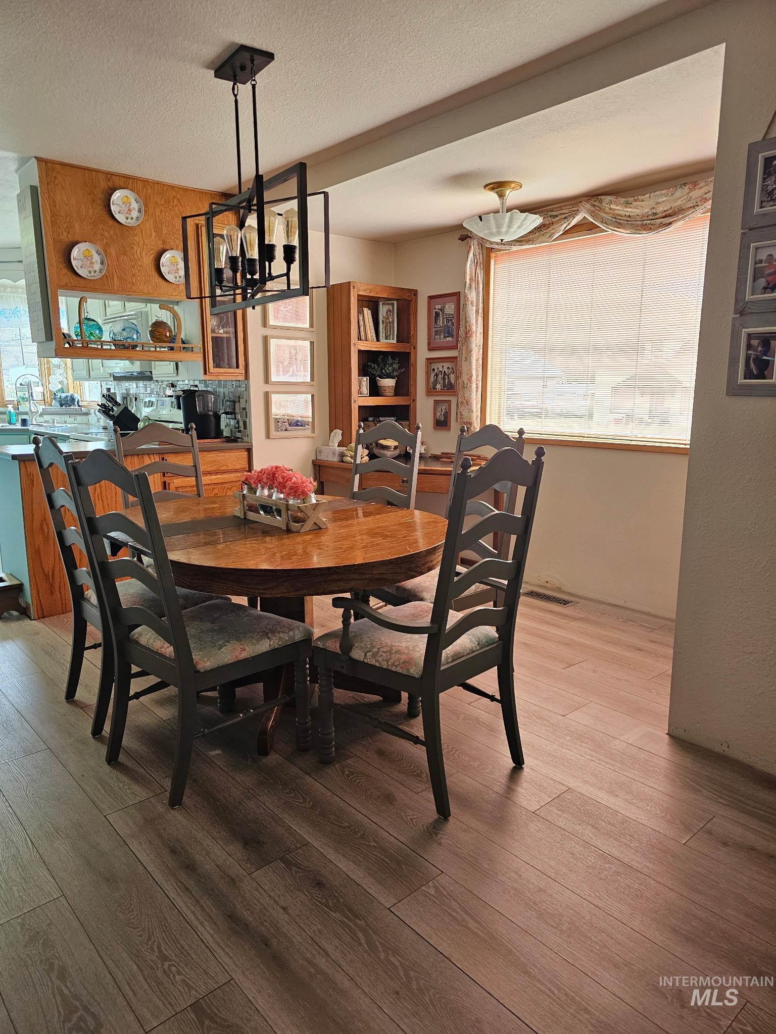1607 Main Street Pomeroy, WA 99347 - Photo 2 of 28 Dining area featuring light wood-style flooring, a textured ceiling, and a chandelier