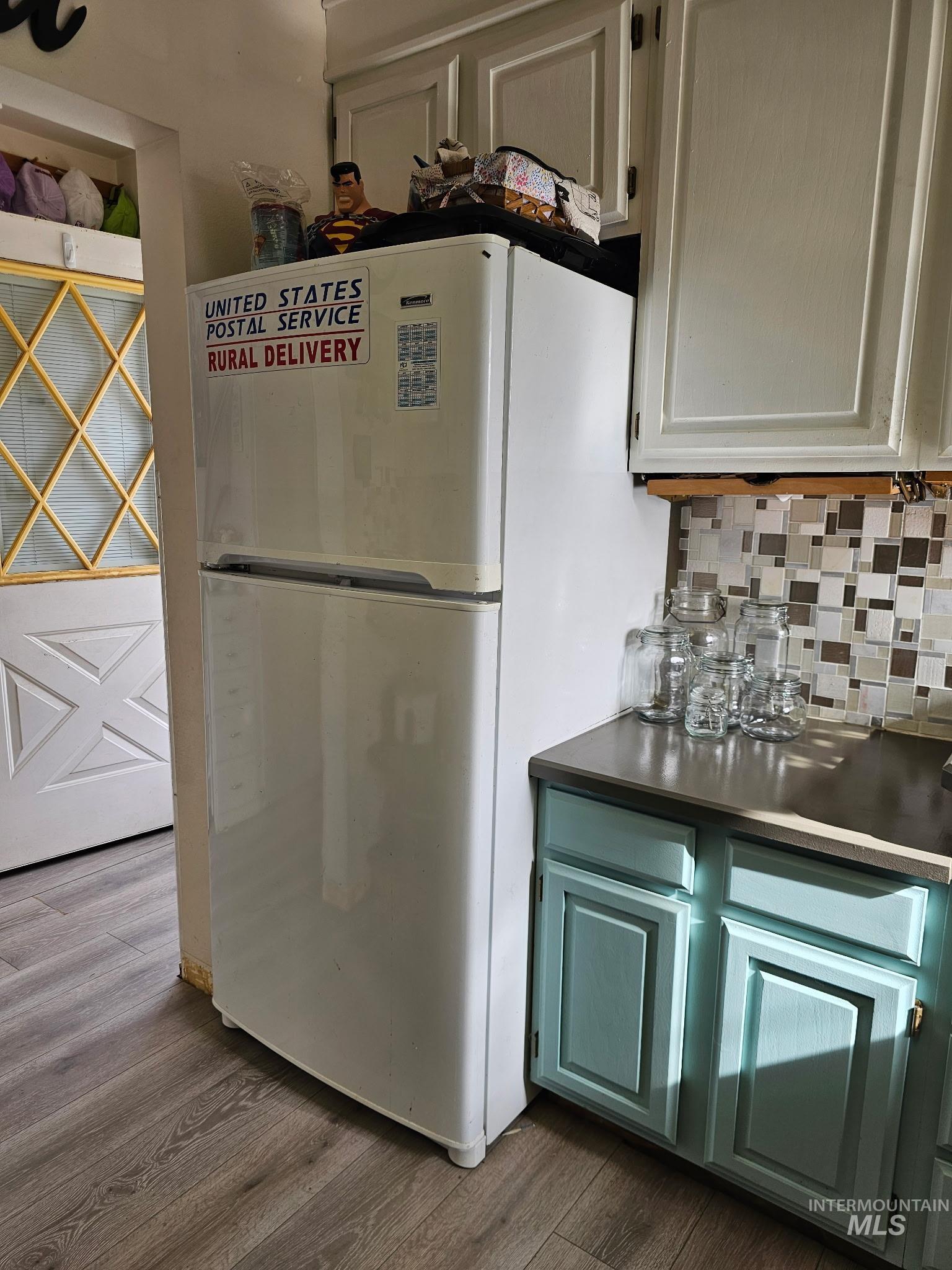 1607 Main Street Pomeroy, WA 99347 - Photo 9 of 28 Kitchen with freestanding refrigerator, dark wood finished floors, tasteful backsplash, and dark countertops