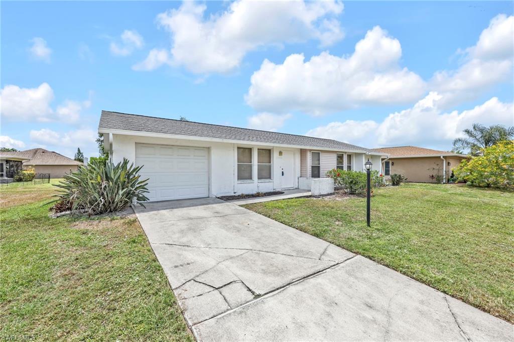 140 Blue Ridge Drive Naples, FL 34112 - Photo 1 of 26 Single story home with a garage, concrete driveway, a front lawn, and stucco siding