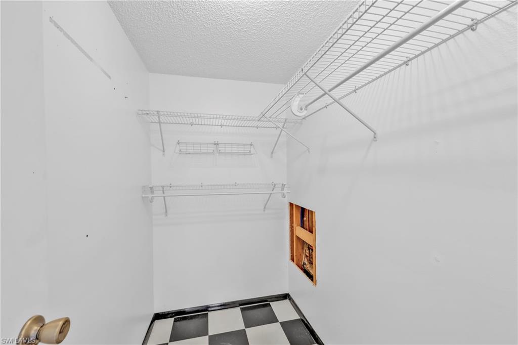 140 Blue Ridge Drive Naples, FL 34112 - Photo 16 of 26 Spacious closet featuring tile patterned floors