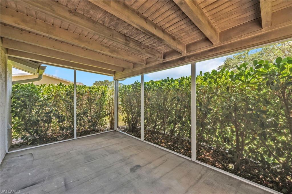 140 Blue Ridge Drive Naples, FL 34112 - Photo 23 of 26 Unfurnished sunroom featuring beam ceiling