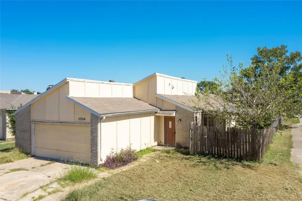 a view of a house with a yard and garage