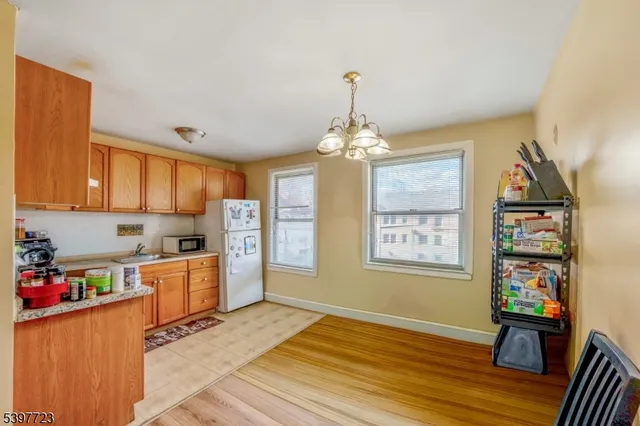 a view of a kitchen and an empty room