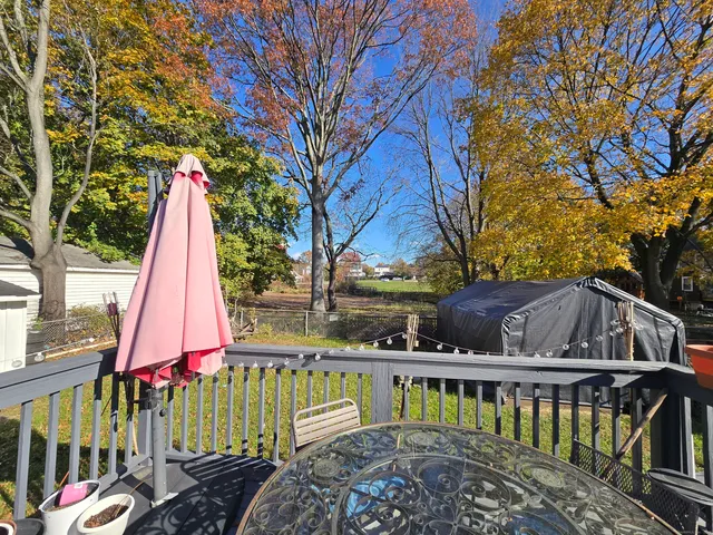 a backyard of a house with table and chairs