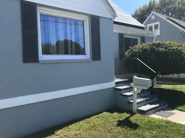 a living room with furniture potted plant and a window