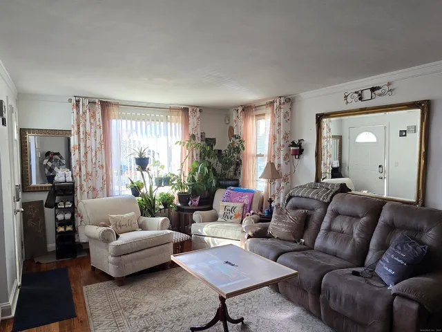 a bedroom with a bed and a mirror on the dresser