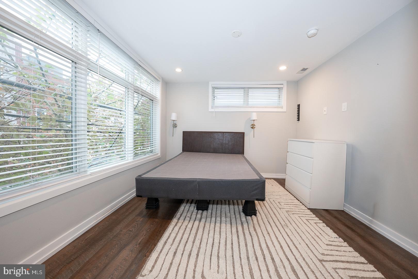 769 North Uber Street, Unit 2 Philadelphia, PA 19130 - Photo 17 of 23 a living room with a bed and wooden floor