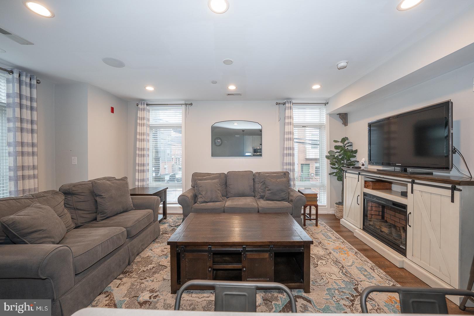 769 North Uber Street, Unit 2 Philadelphia, PA 19130 - Photo 2 of 23 a living room with furniture and a flat screen tv