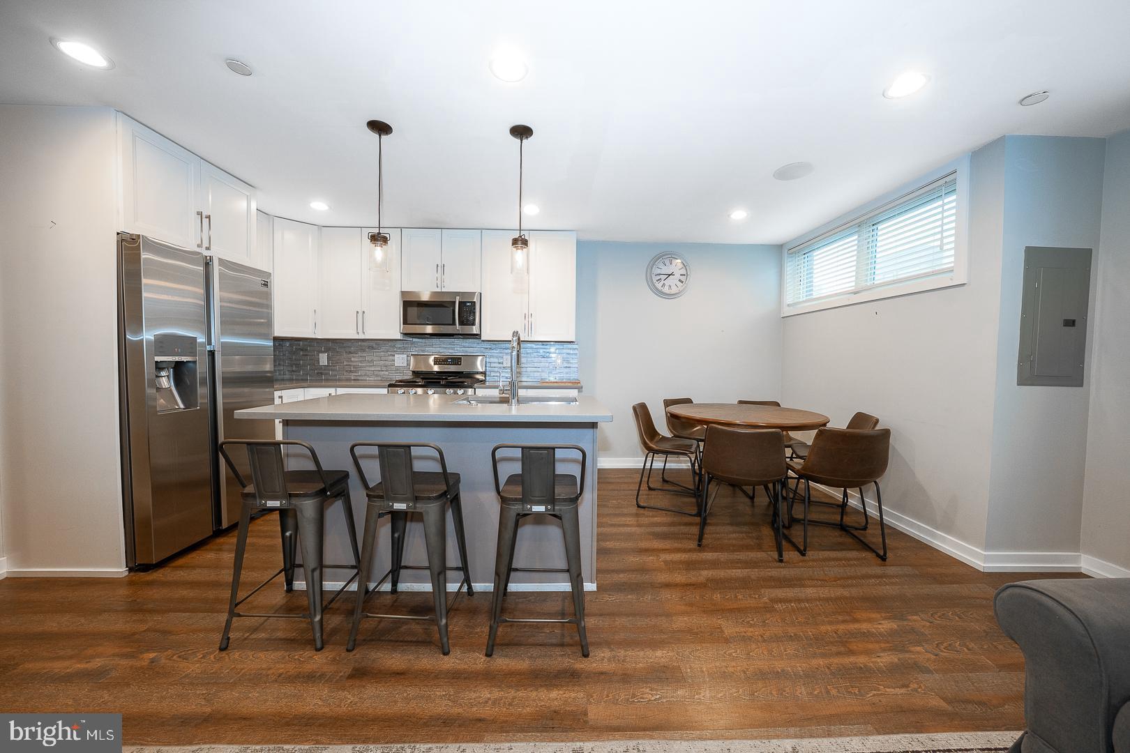 769 North Uber Street, Unit 2 Philadelphia, PA 19130 - Photo 5 of 23 a kitchen with stainless steel appliances kitchen island granite countertop a sink and cabinets