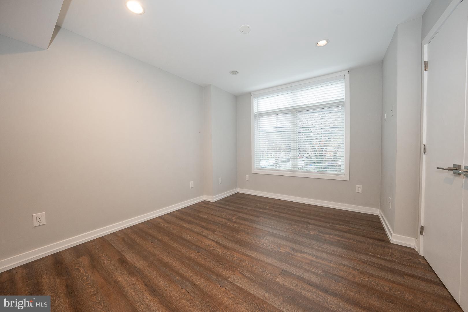 769 North Uber Street, Unit 2 Philadelphia, PA 19130 - Photo 9 of 23 wooden floor in an empty room with a window