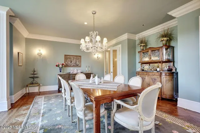 a living room with furniture a large window and a chandelier