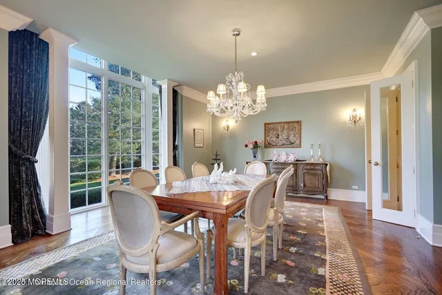 a large kitchen with stainless steel appliances a large counter top a stove a sink and a refrigerator