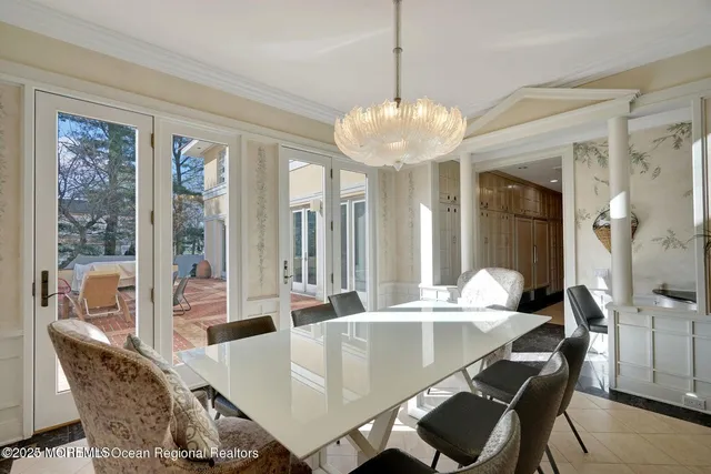 a view of a hallway with wooden floor and a bathroom