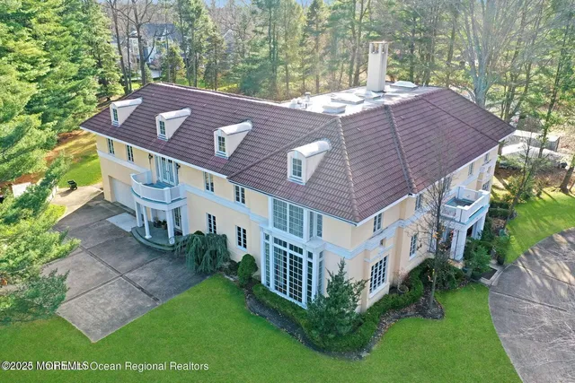 front view of a house with a yard and a fountain