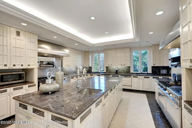 a bedroom with a bed and a large window with the outer view