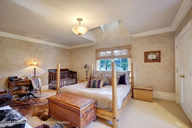 a spacious bedroom with two beds and large windows
