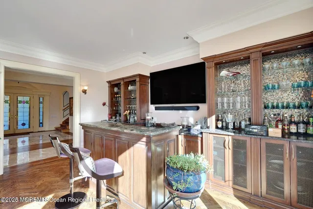 a living room with furniture a large window and a chandelier